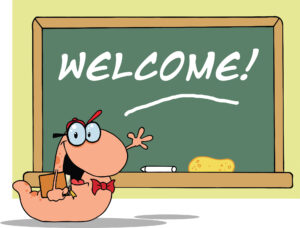 1700 waving bookworm student in front of school chalk board with text welcome 1